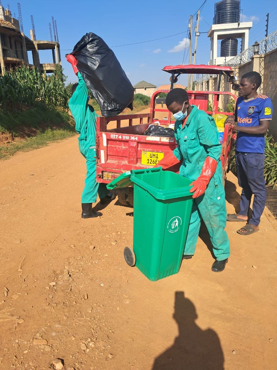 RERU collection crew picking up household waste in Nsasa Estate